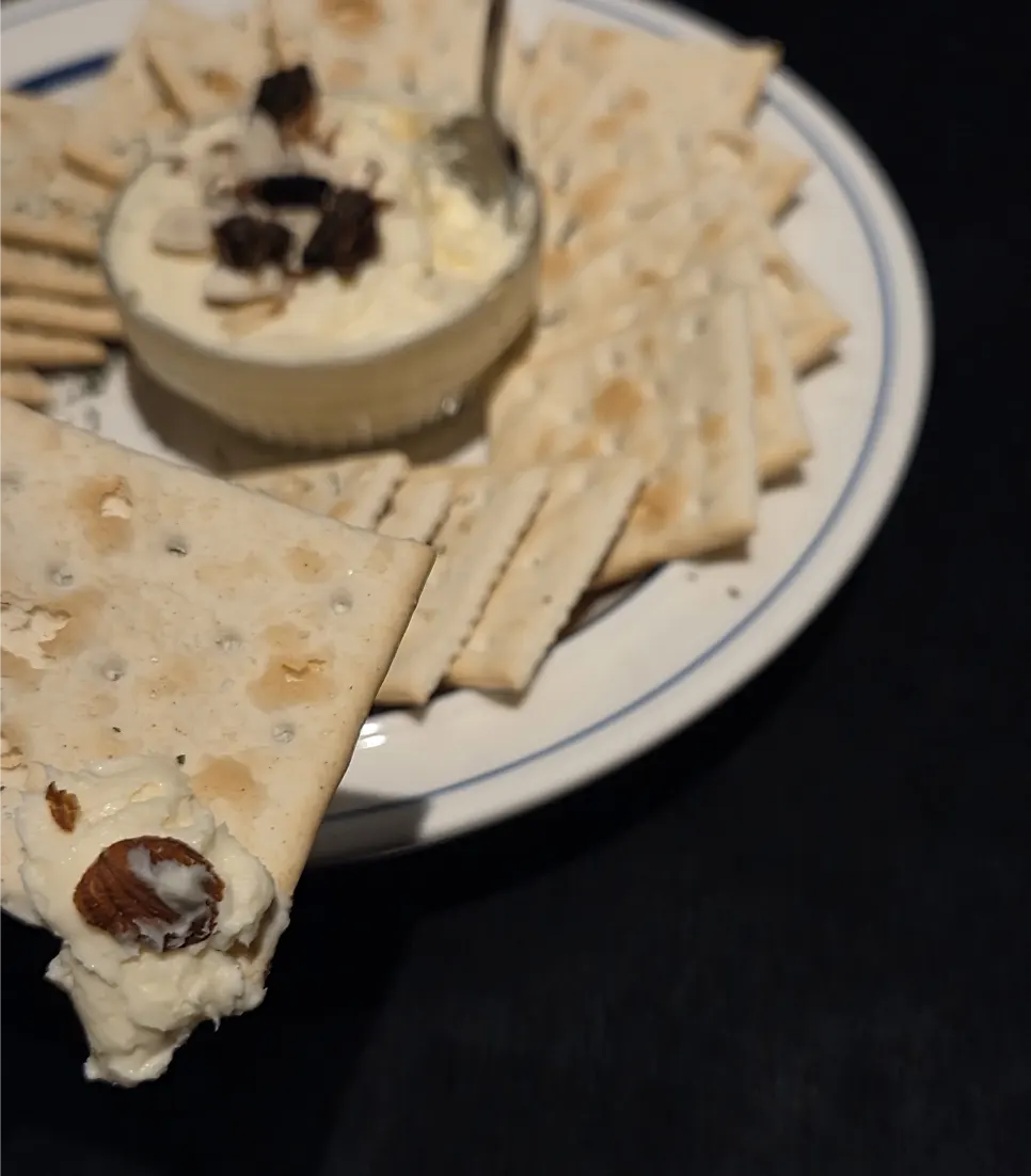 Honey cream cheese crackers served alongside a cocktail