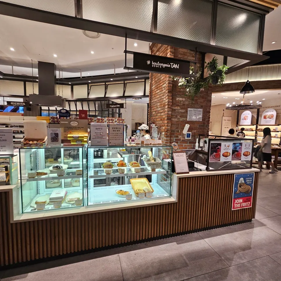 Storefront visible to the left when coming down the escalator