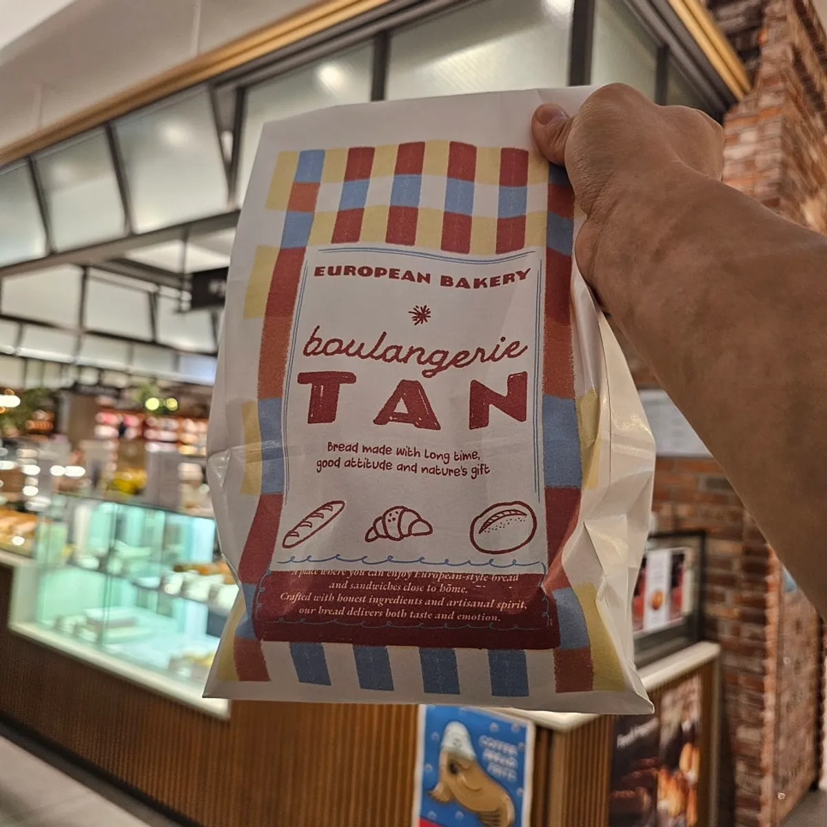 Paper bag stamped with the store logo
