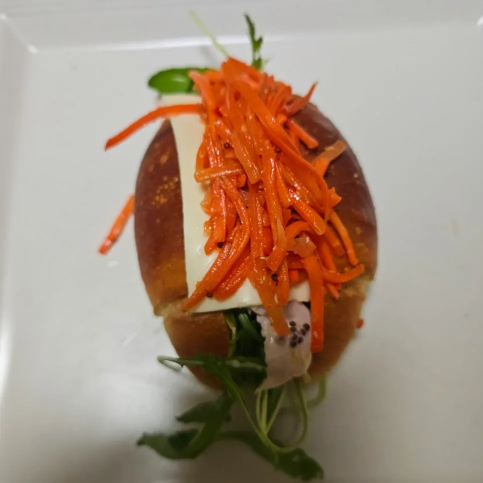 Cross-section of the sandwich showing cheese, arugula, and chicken breast