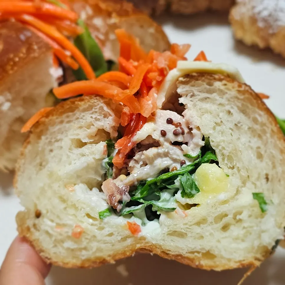 A bite taken out of the sandwich showing the packed filling