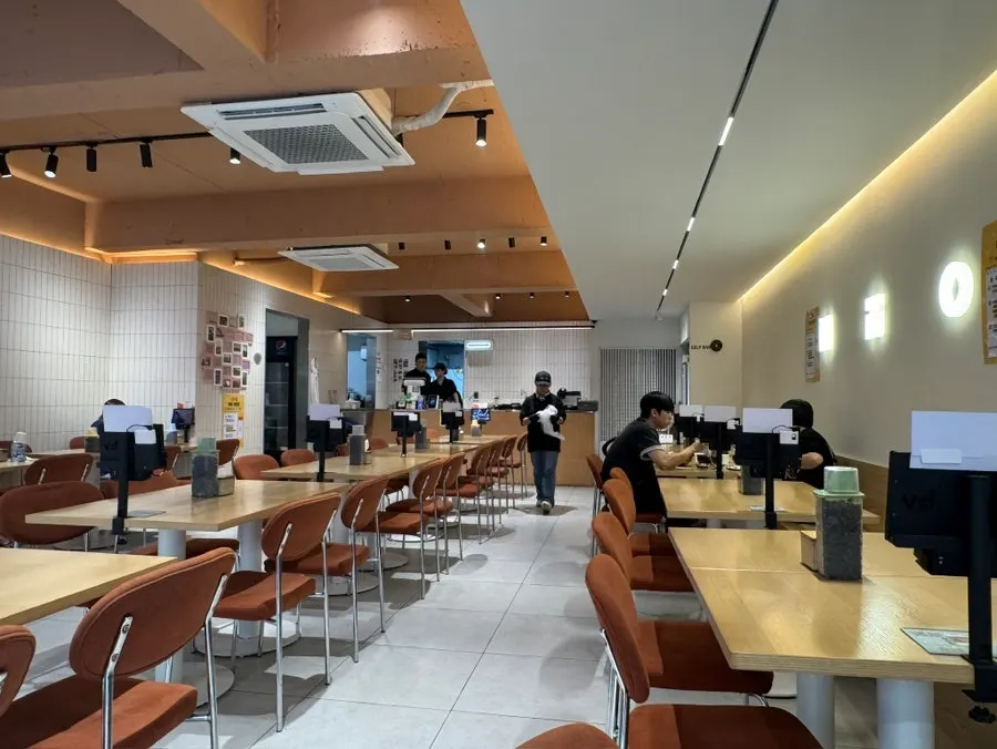 Long row of tables stretching to the back of the restaurant