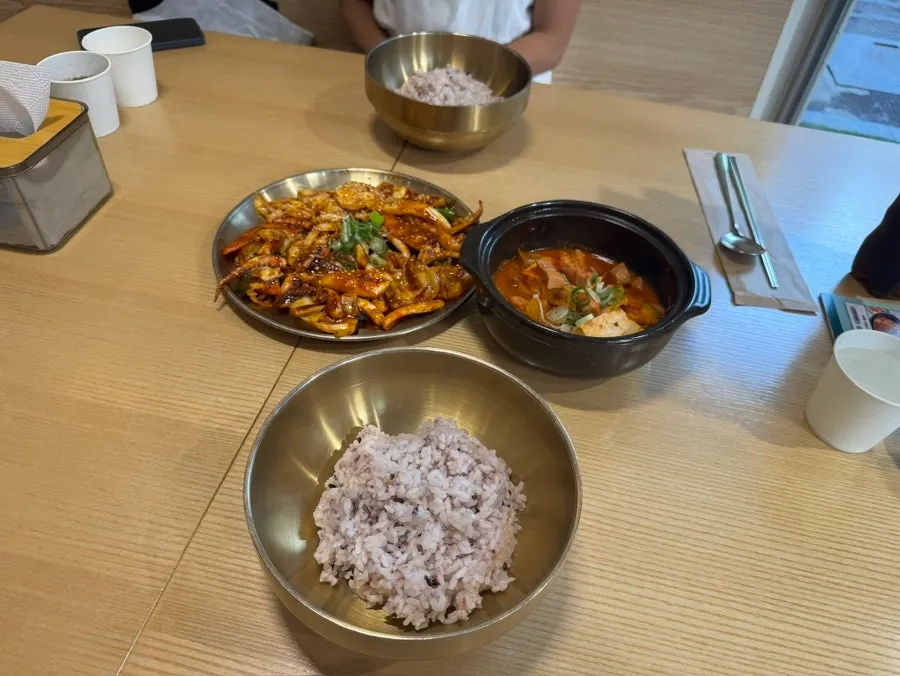 Table spread for two including multigrain rice in a brass bowl