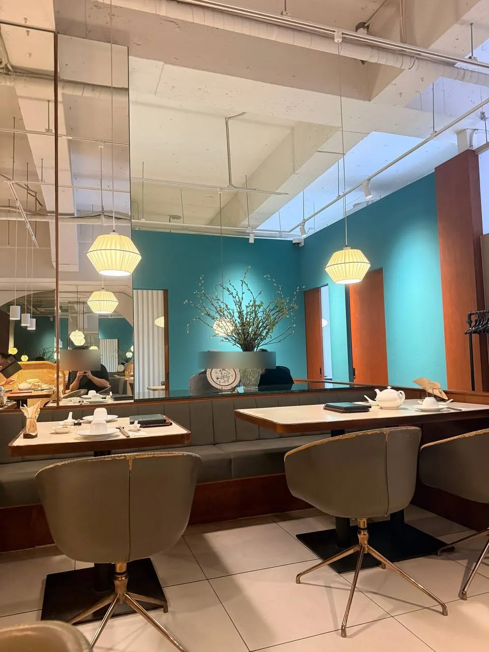 Dining room view with mint walls and wooden tables