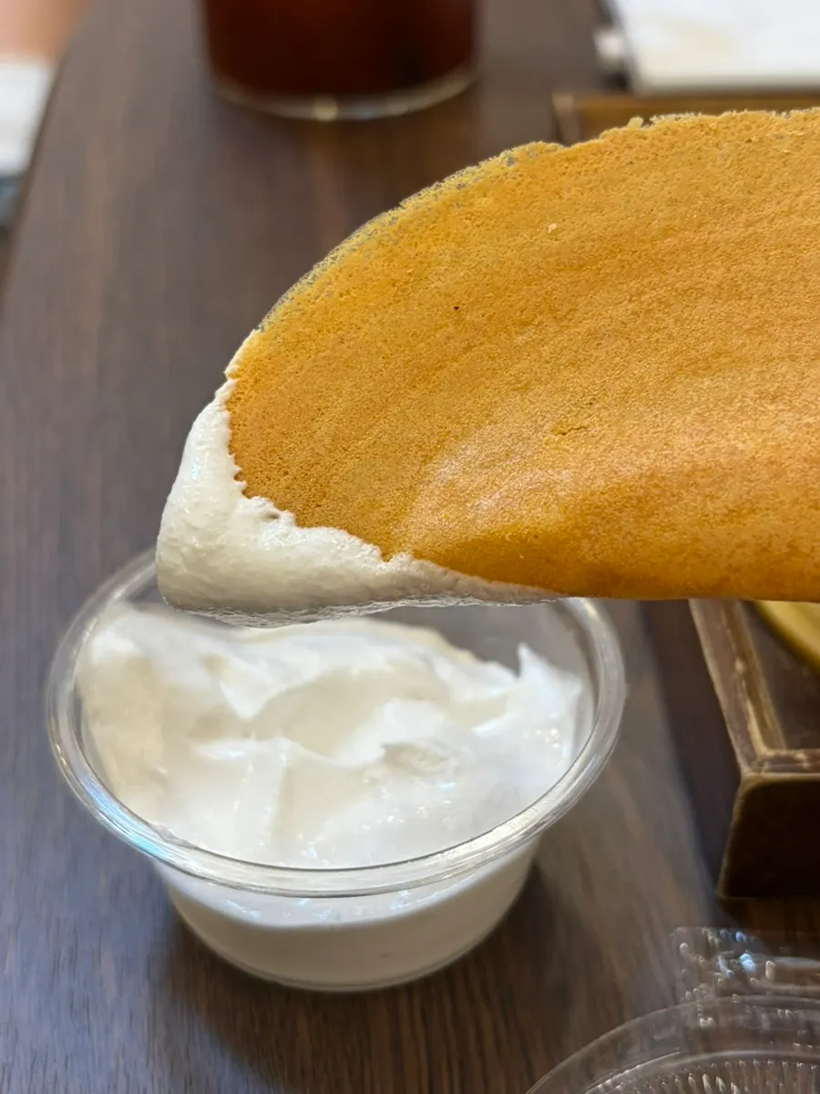 A piece of bocado dipped in coconut dipping cream