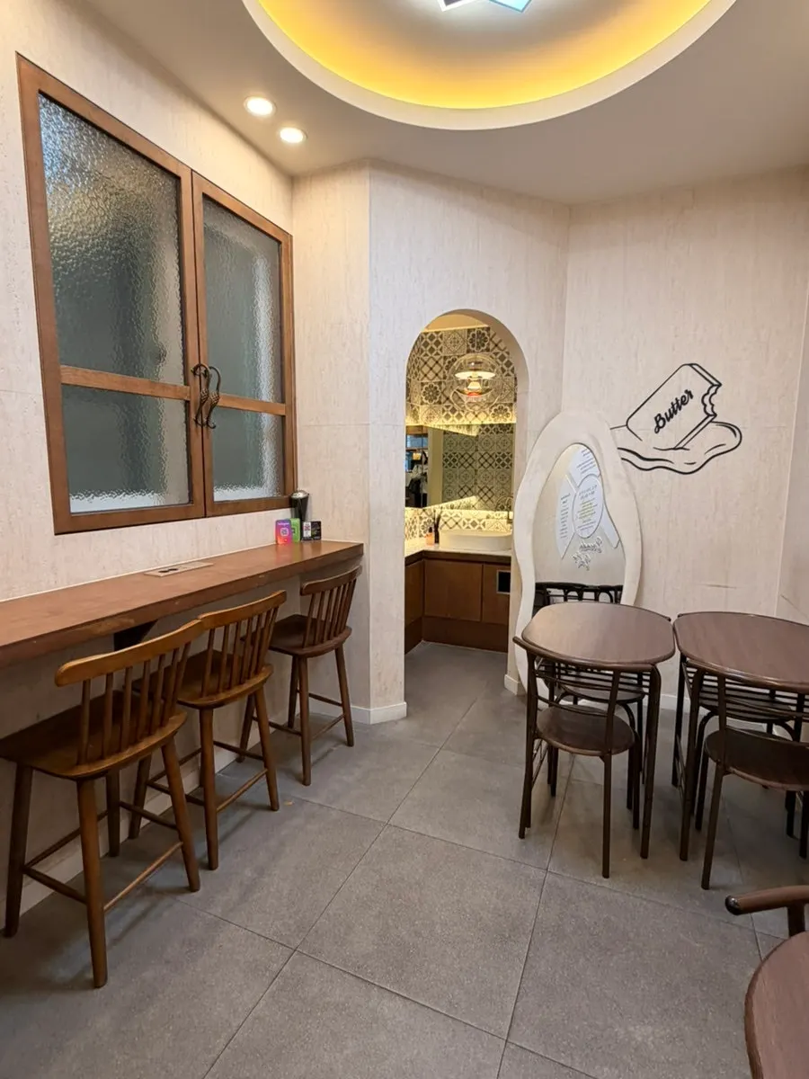 Bar table with wooden chairs at Bocado Butter Seongsu Main Store