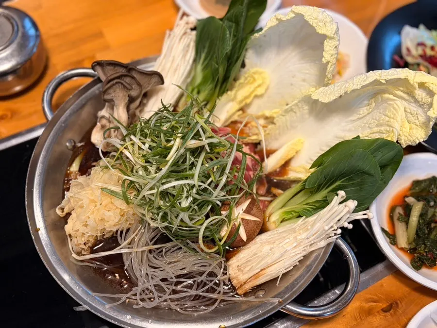 Mushroom bulgogi hot pot simmering at the table