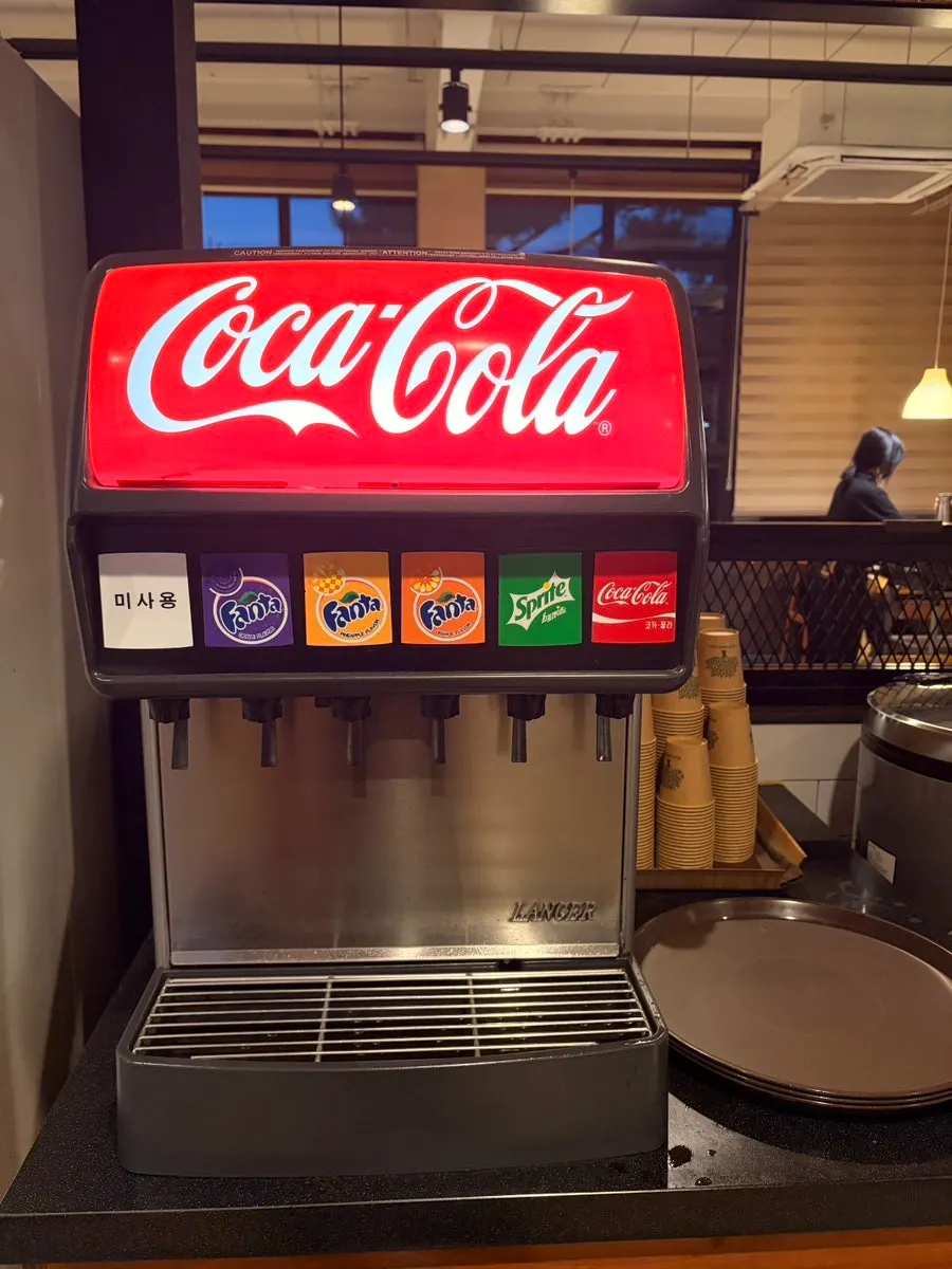 Soda machine on one side of the self-serve bar