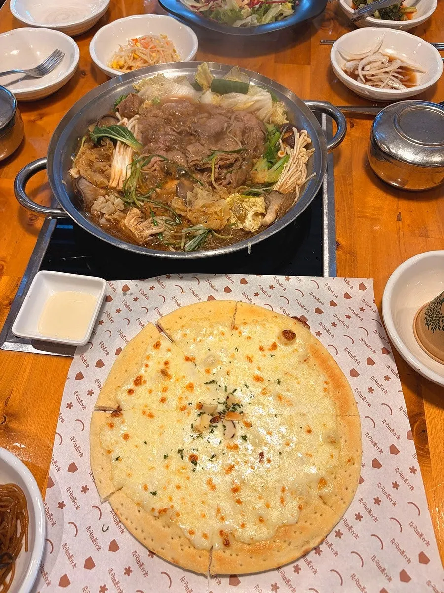 Table with the mushroom bulgogi hot pot at the end of the family dinner