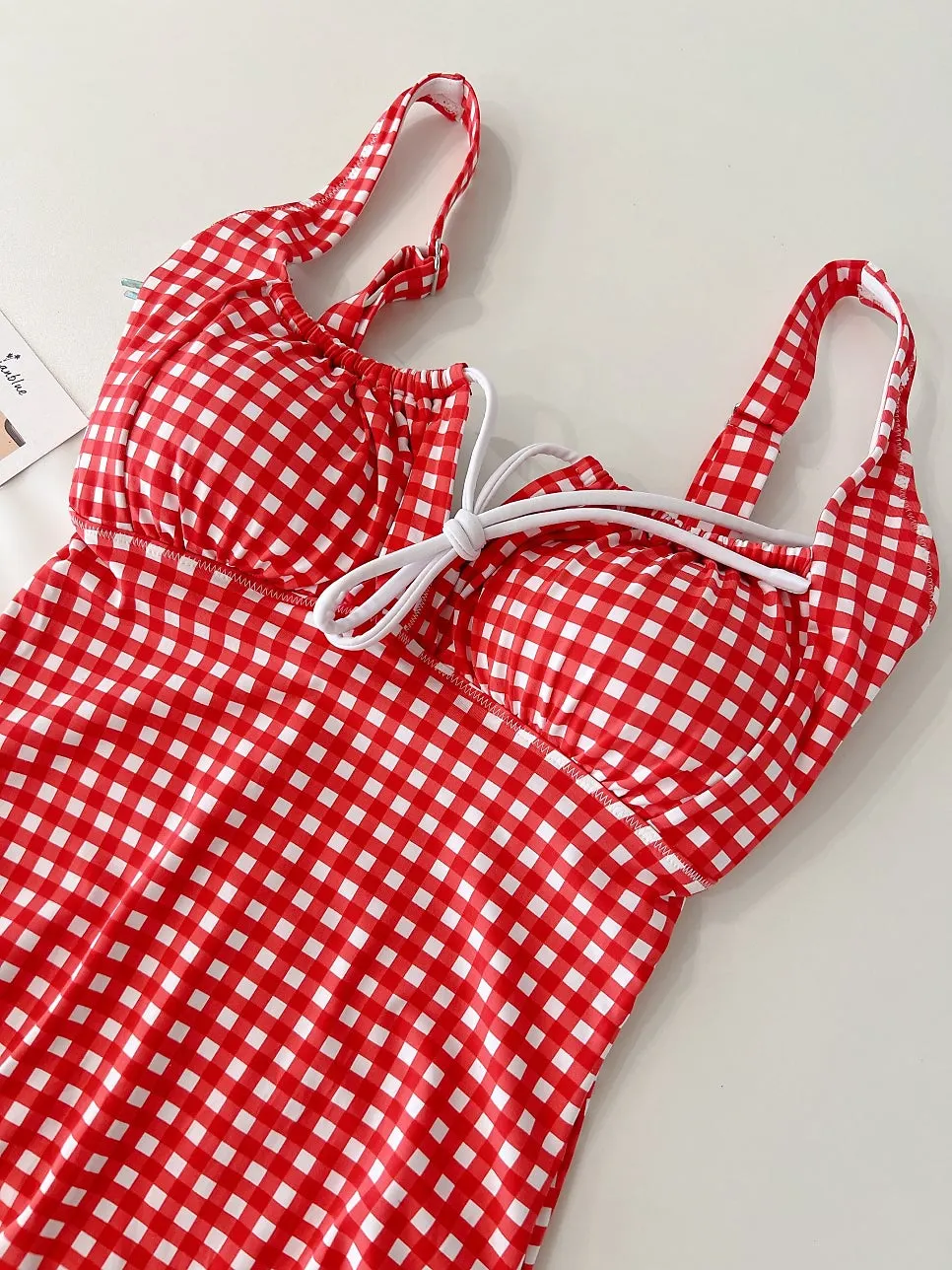 Ribbon tie-up detail on the gingham one-piece swimsuit