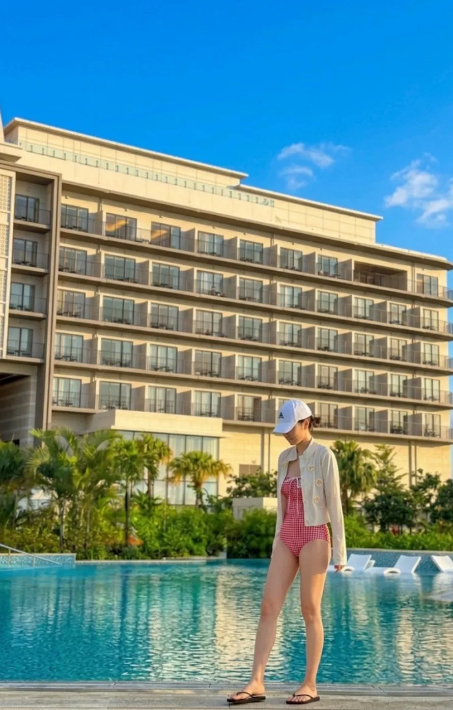 A rash guard worn over the gingham check swimsuit