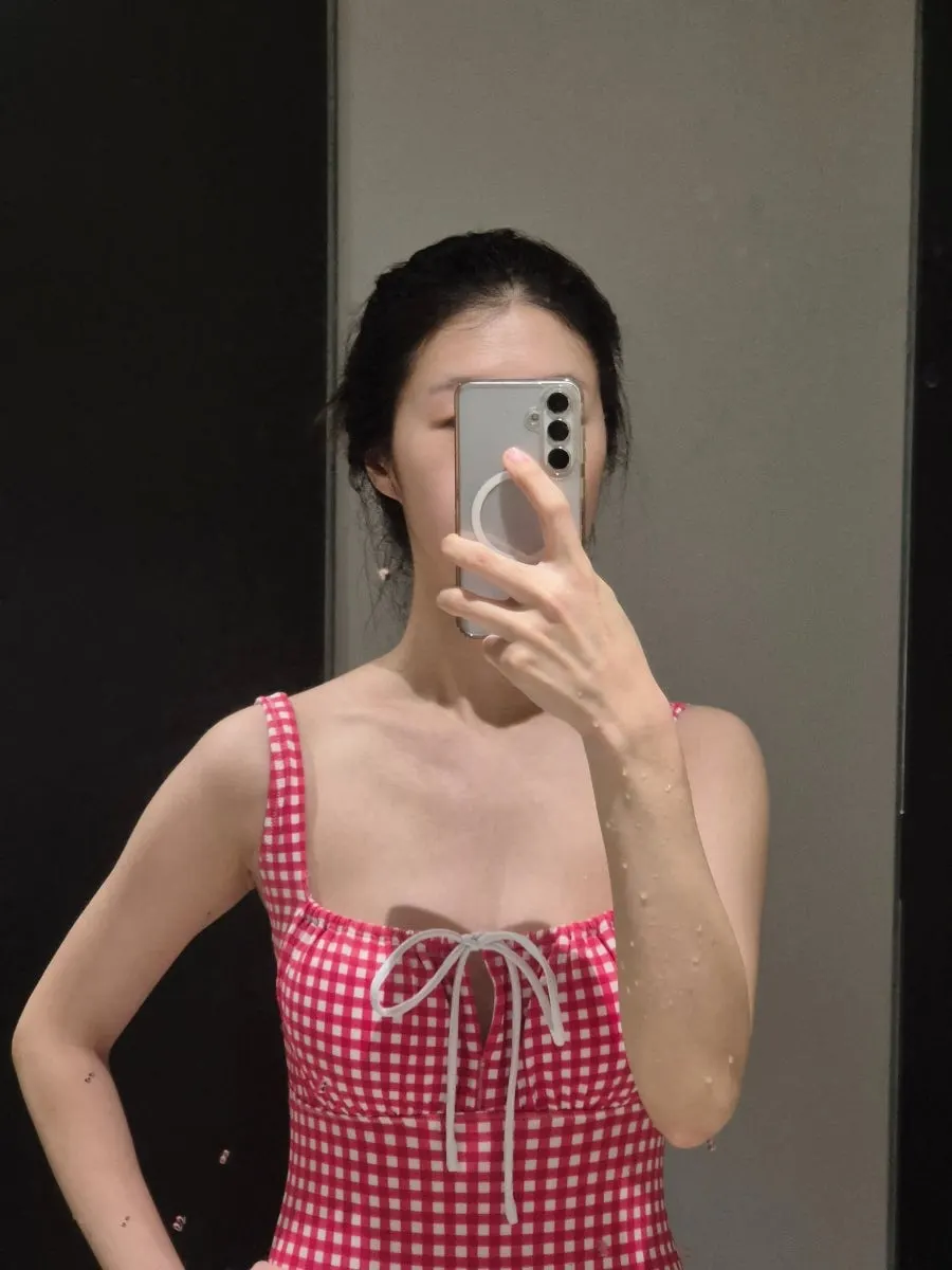 Red checked one-piece swimsuit chosen for travel