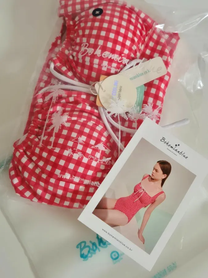 Checked one-piece swimsuit packed for a hot-spring resort trip