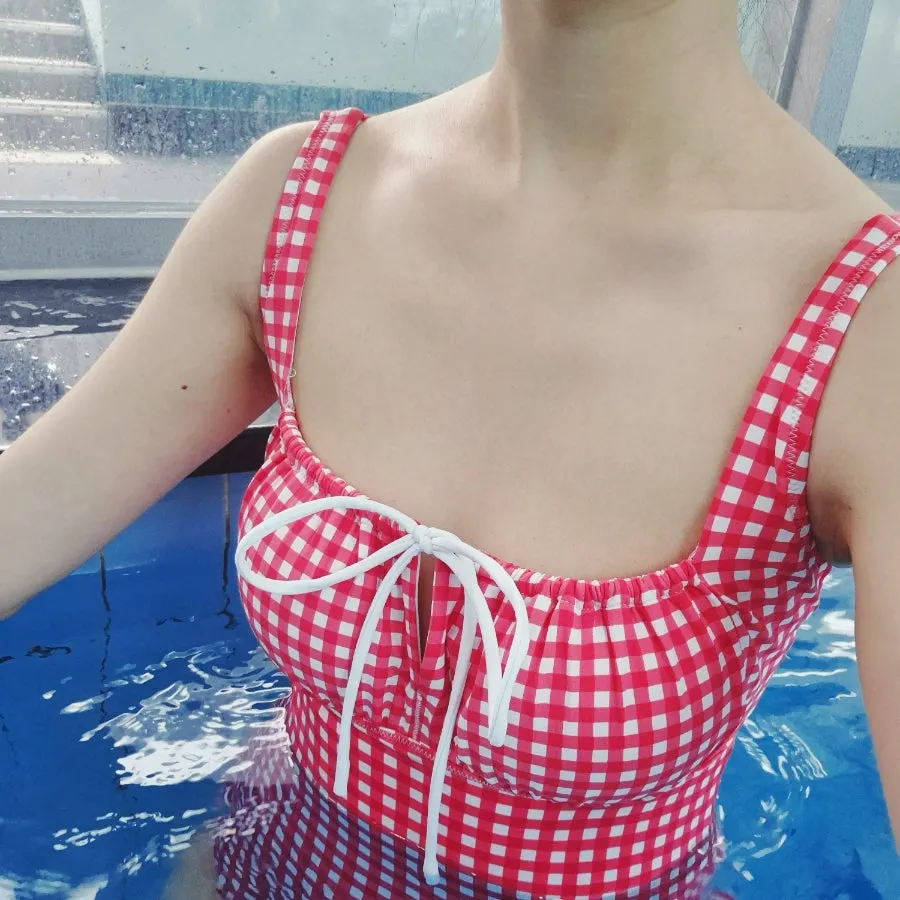 One-piece swimsuit with a vivid red check pattern