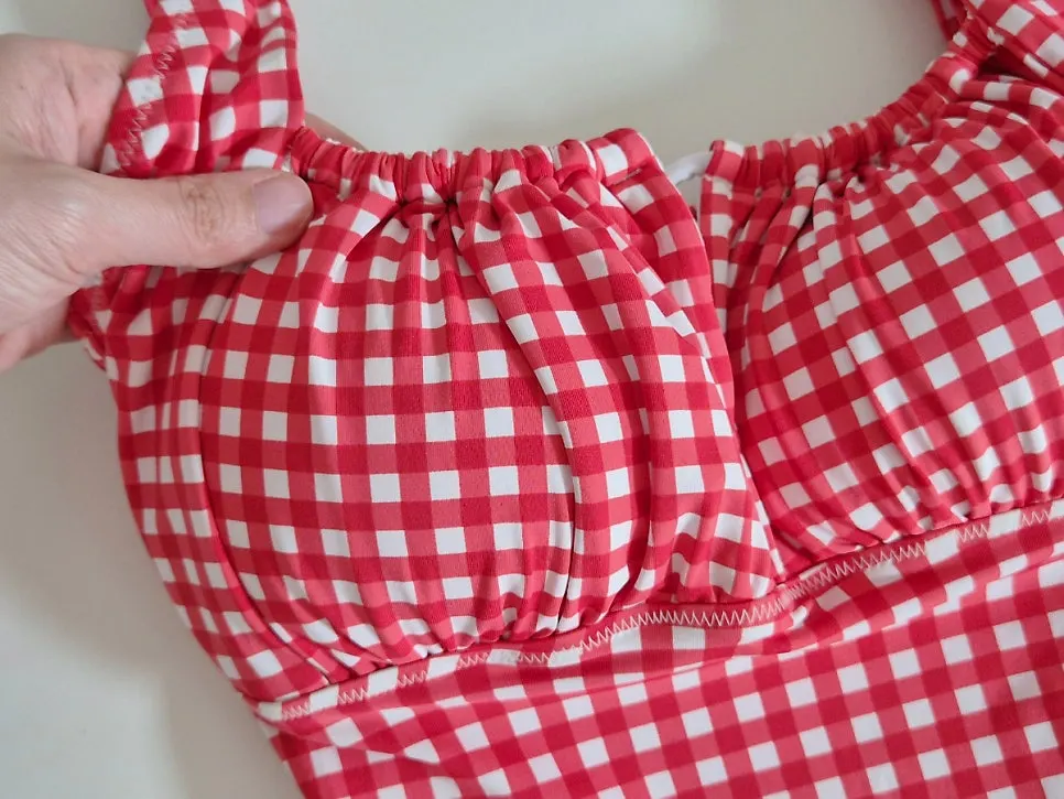 Red checked one-piece swimsuit worn on a trip
