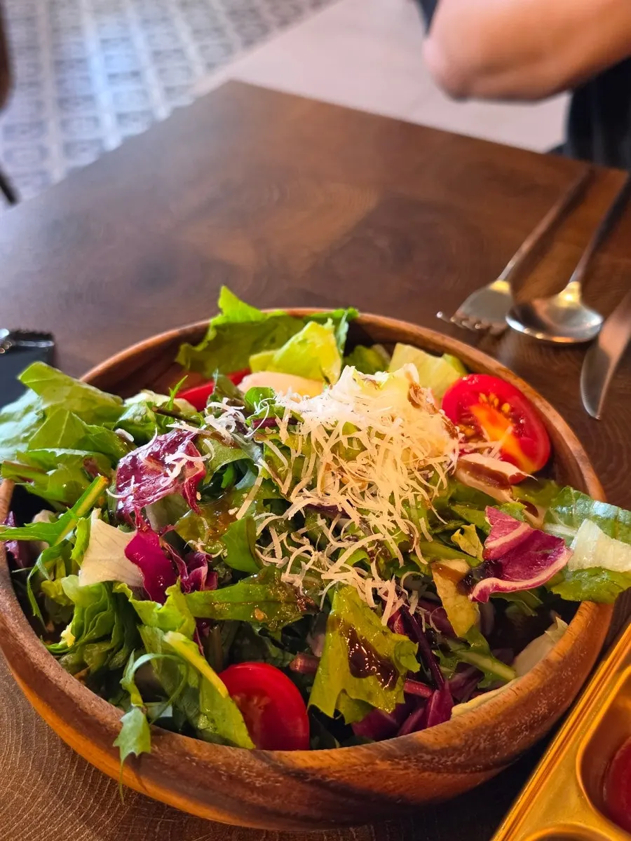 Garden salad topped with balsamic and cheese