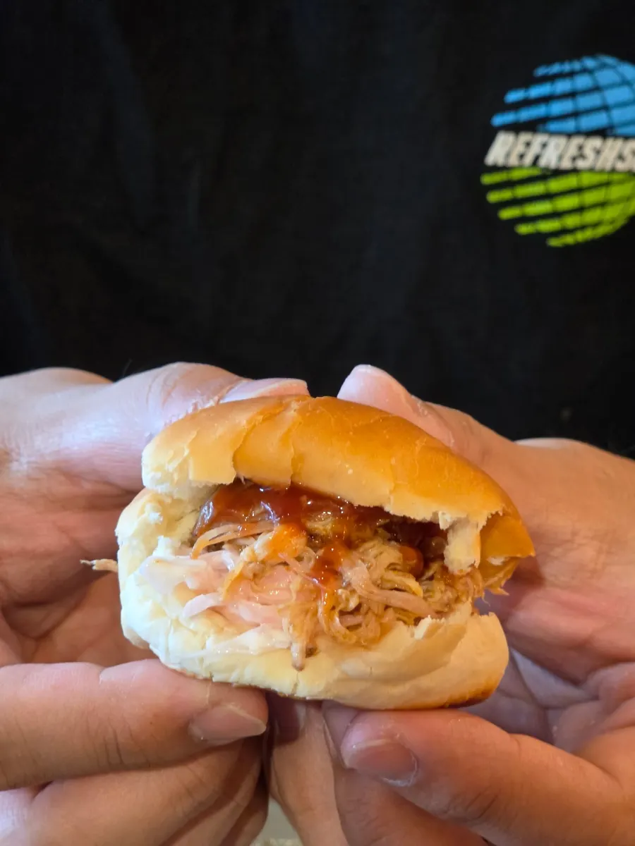 Mini burger made with pulled pork and coleslaw in a butter bun