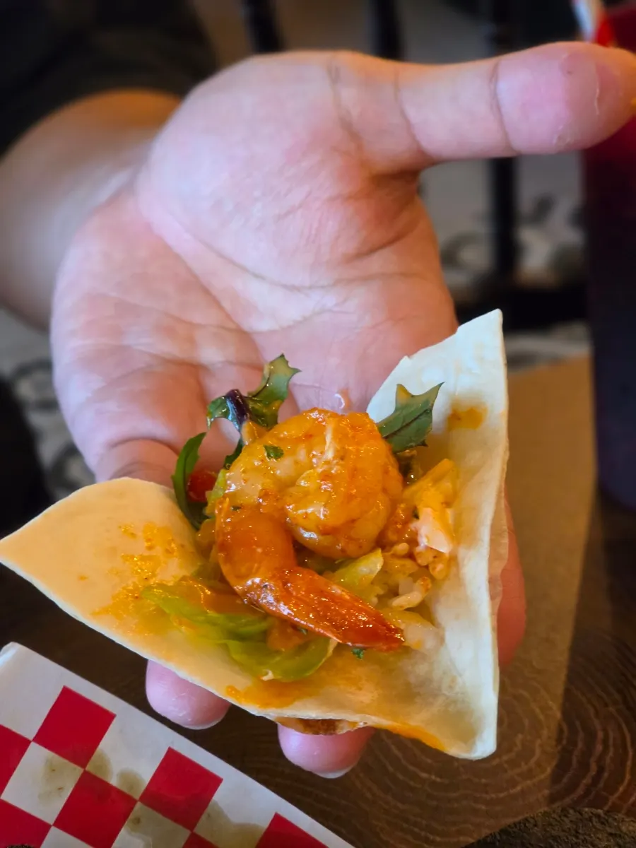 Taco rice topped with spicy shrimp and sour cream