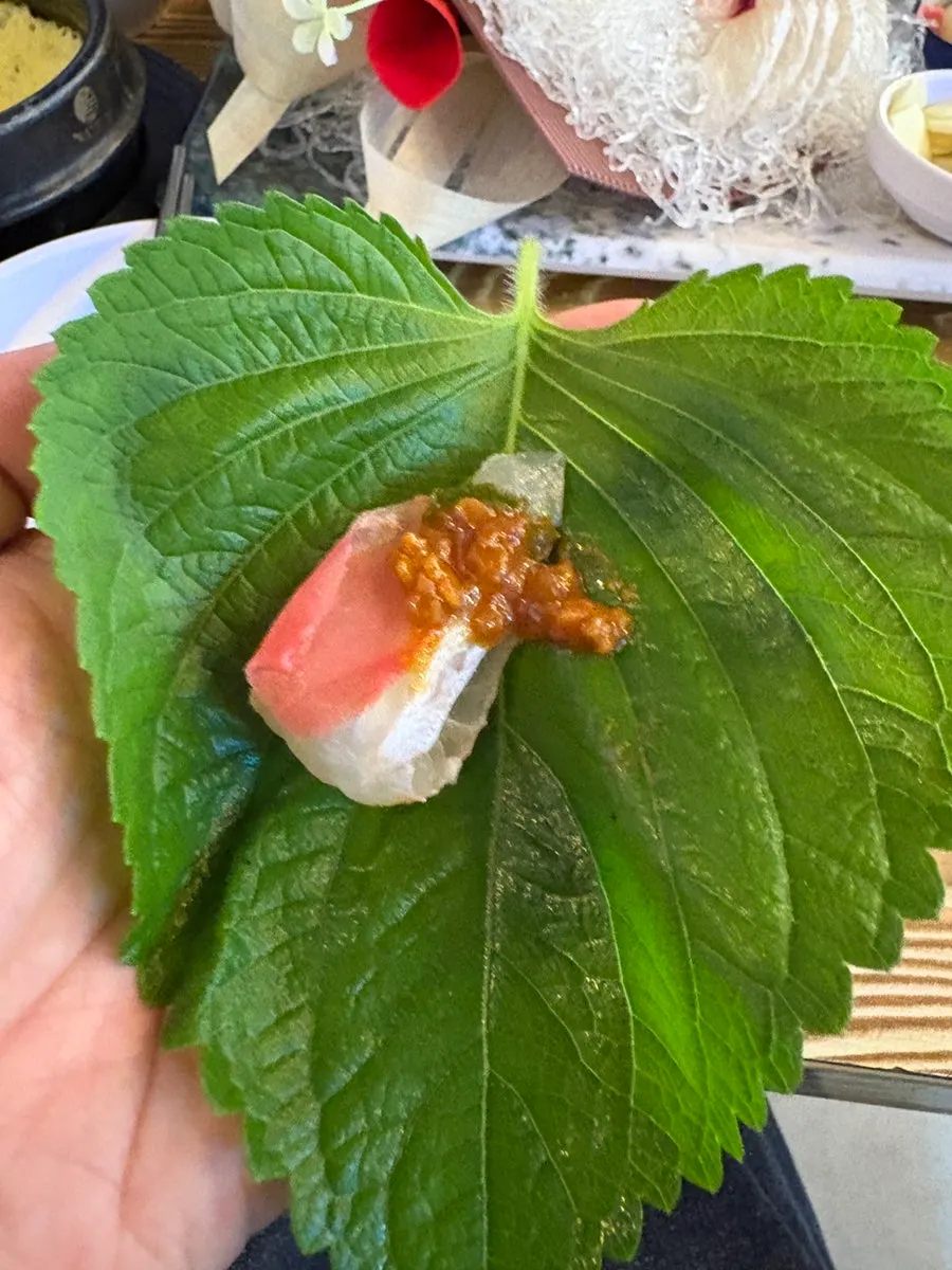 Sashimi placed on fresh wrap vegetables