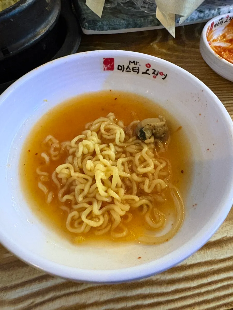 Seafood ramyeon alongside the remaining table spread