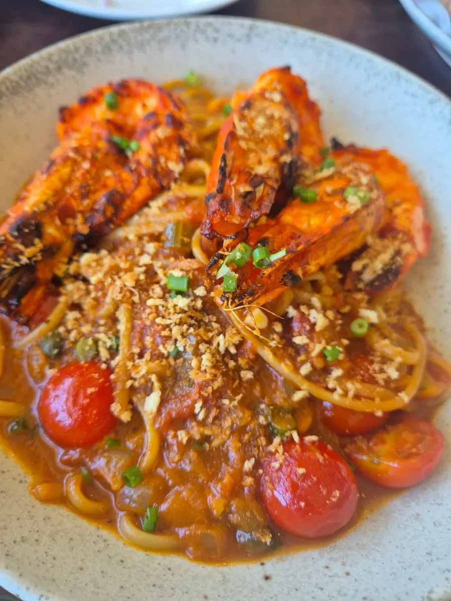 Shrimp bisque pasta topped with large shrimp