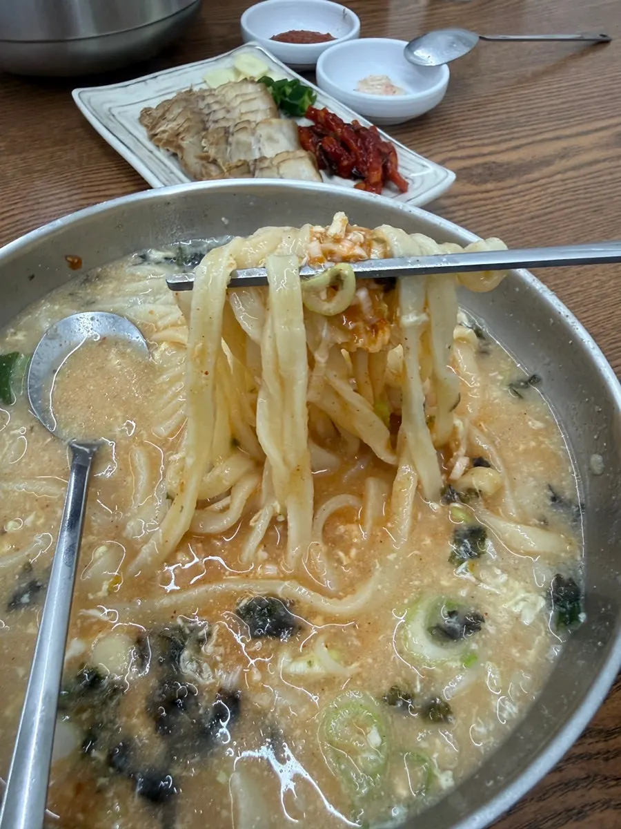 Broth and noodles of the chicken kalguksu with laver topping