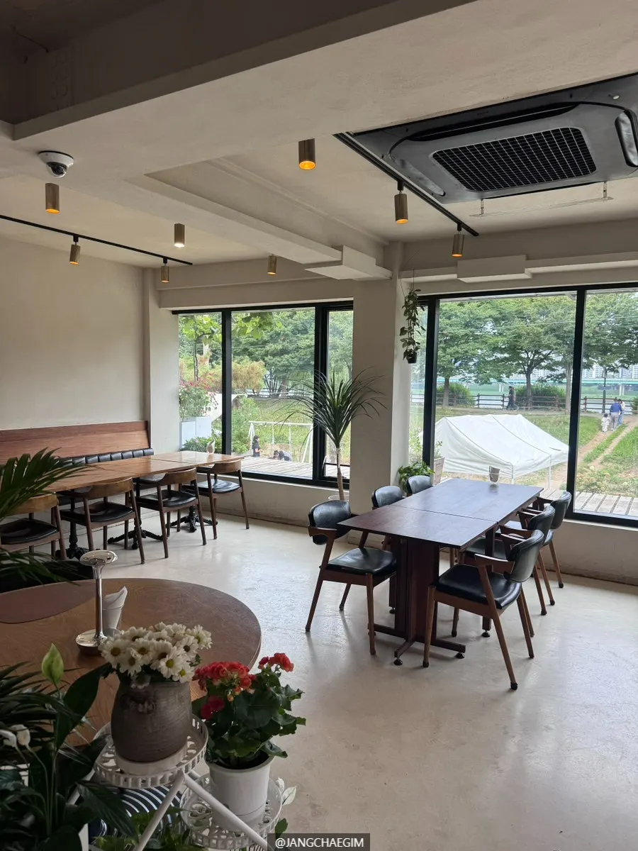Dining hall with floor-to-ceiling windows overlooking the Misa riverside