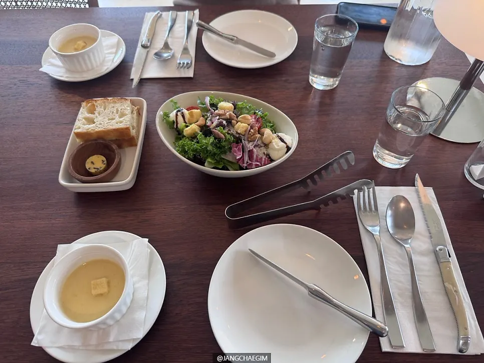 First course of bread, sweet corn soup, and half salad