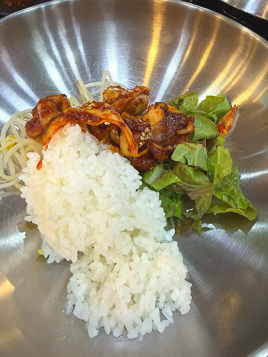 Close-up of jjukkumi stir-fry coated in spicy sauce