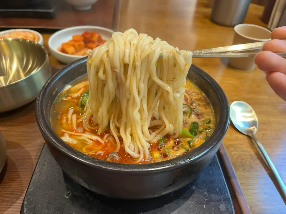Close-up of Boksan Haejang's haejang kalguksu with noodles added