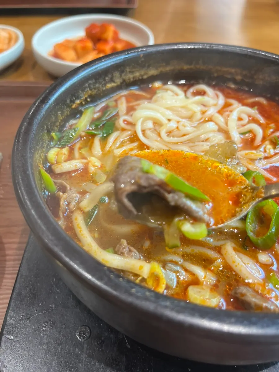 Gukbap portioned into a small bowl with sancho pepper powder added
