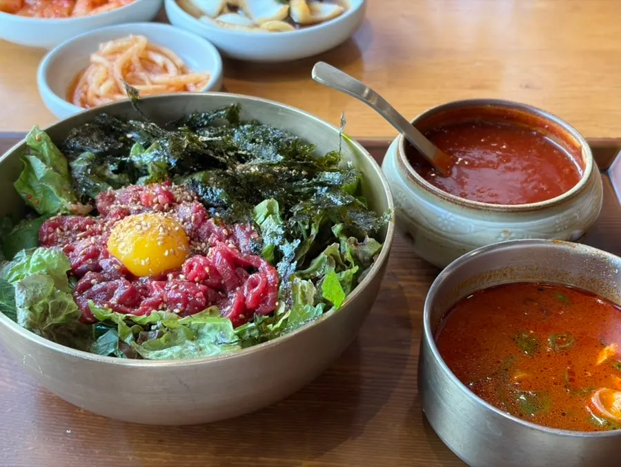 Full serving of Boksan Haejang's yukhoe bibimbap topped with egg yolk