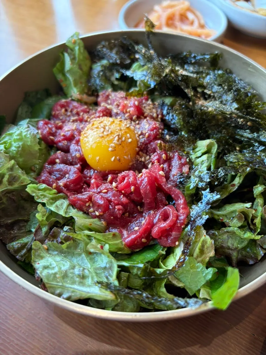 Close-up of yukhoe bibimbap with raw beef and vegetables
