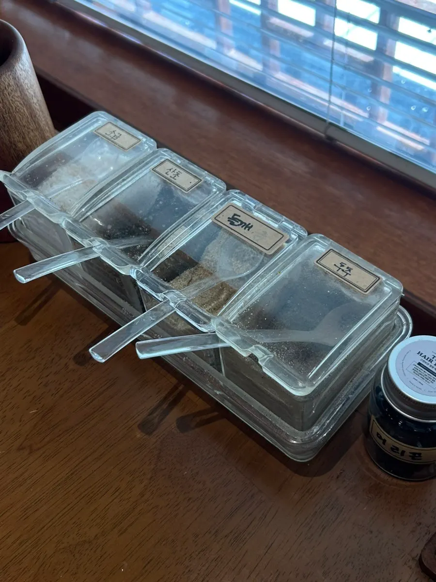 Salt, sansho pepper, perilla seed, and pepper shakers on the table