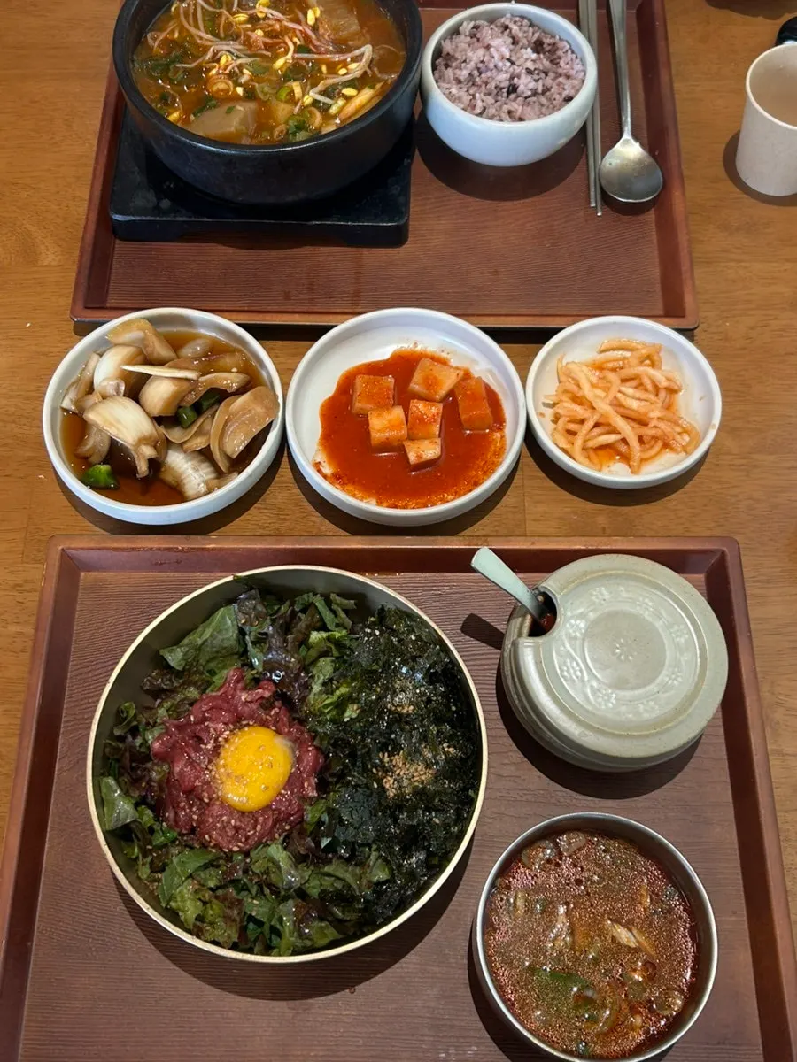 Lunch spread of boksan haejangguk and yukhoe bibimbap
