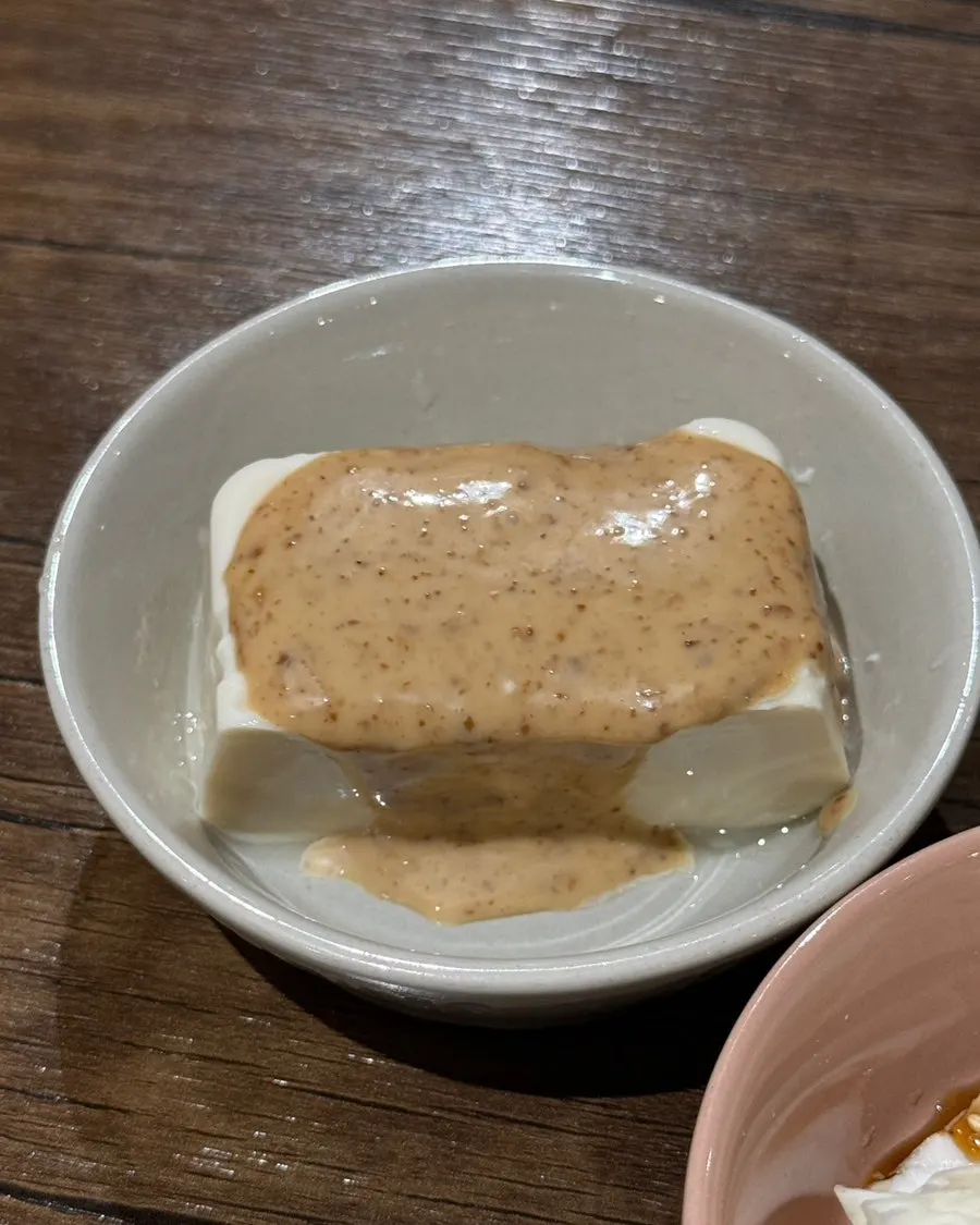 Soft tofu side dish topped with tangy sauce