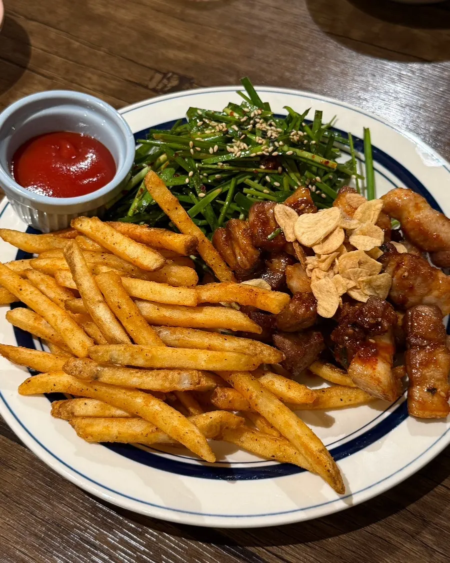 Fries served alongside the spicy chives pork belly