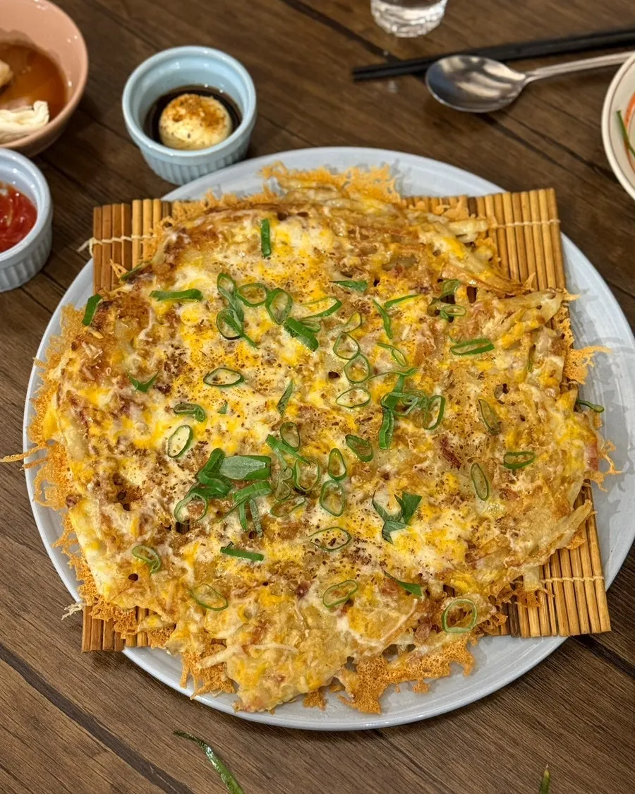 Cheese potato pancake piled high with melted cheese at Boktae Pocha