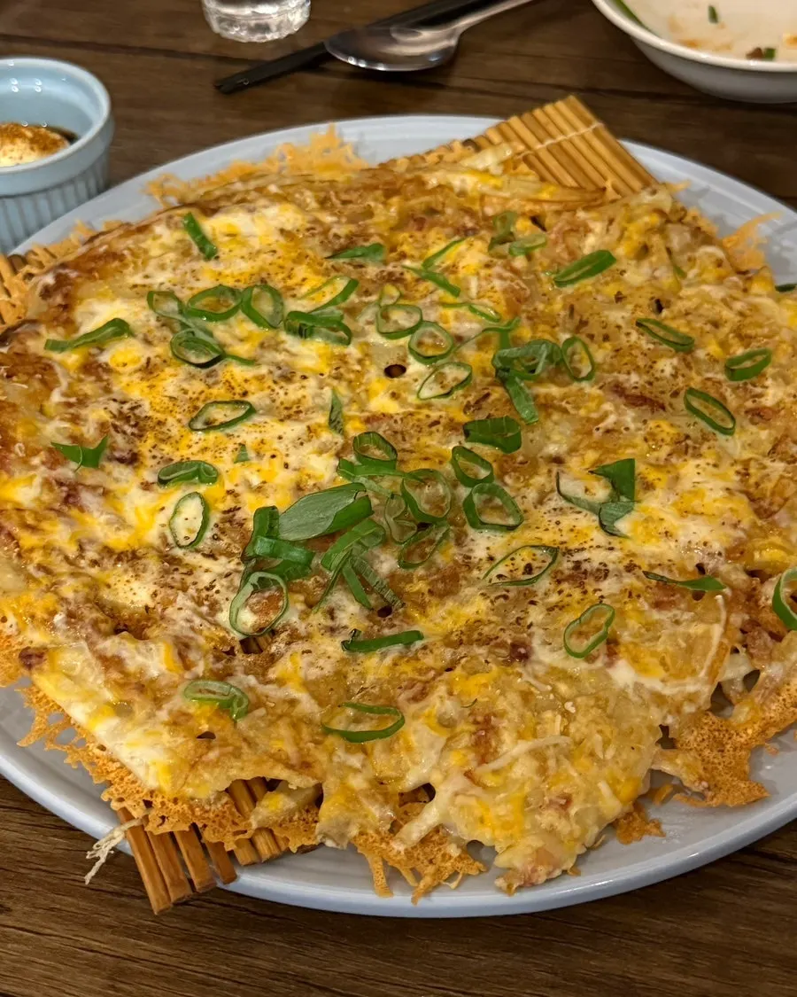 Potato pancake with julienned potato covered in cheese