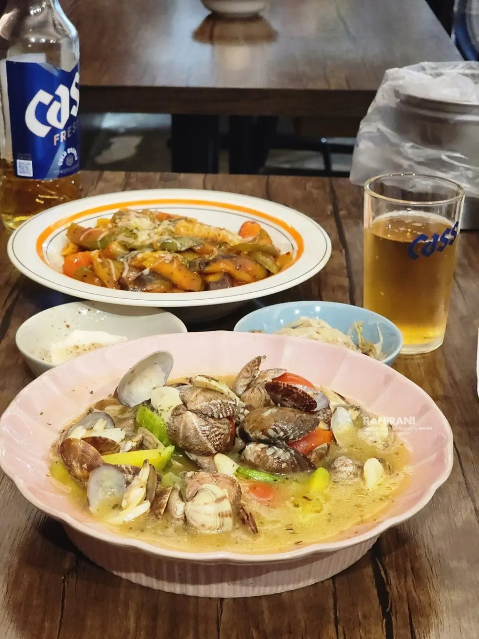 Table spread of drinks and snacks at Boktae Pocha near Nonhyeon Station
