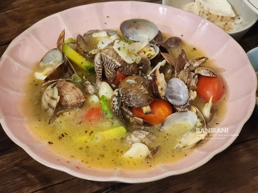 Clam soup with zucchini and cherry tomatoes