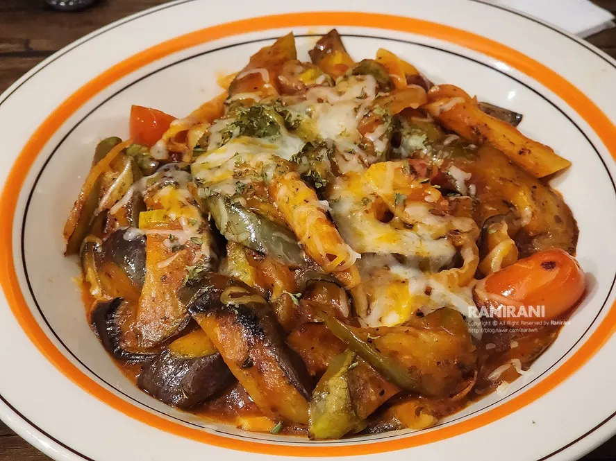 Close-up of melted cheese on the tomato eggplant stir-fry