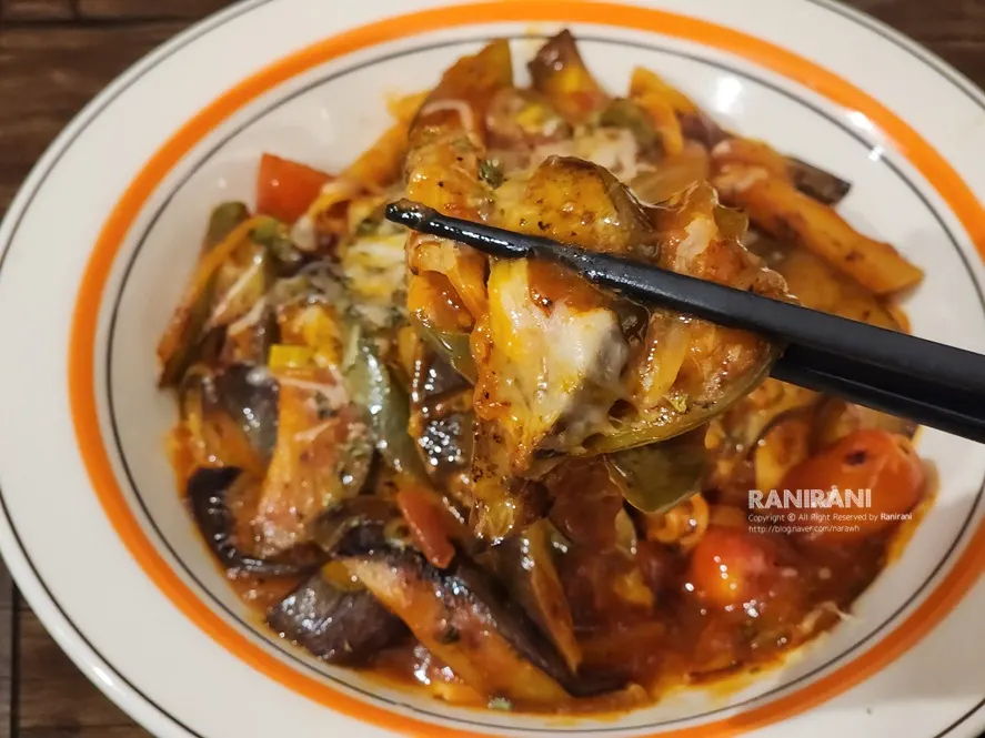 Tomato eggplant stir-fry served alongside beer