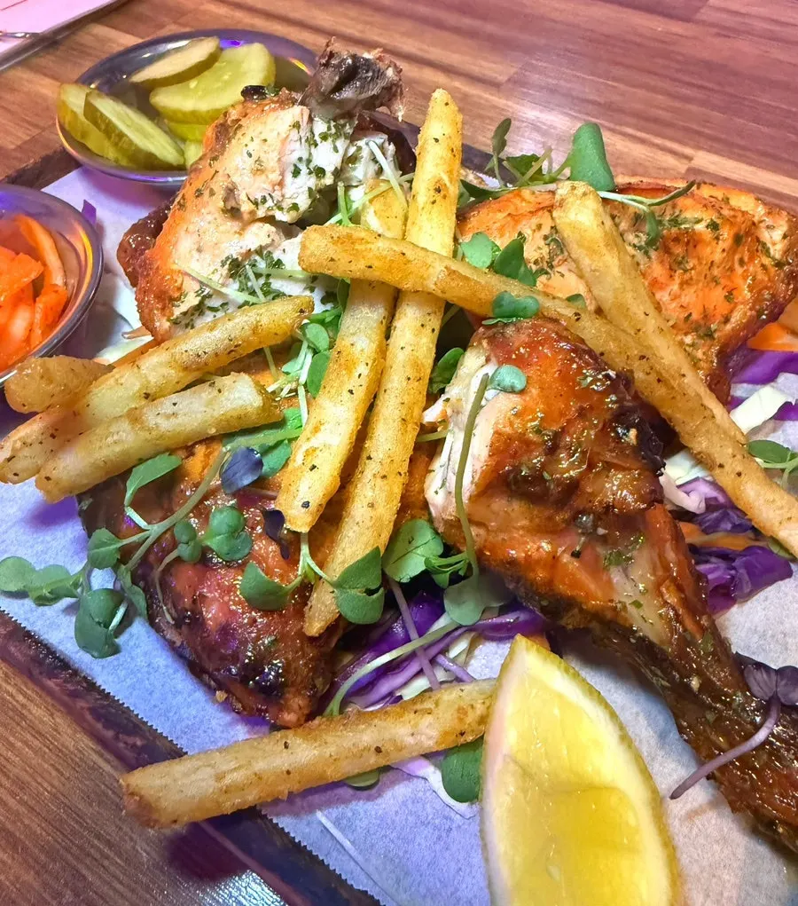 Tandoori chicken picked up and ready to eat
