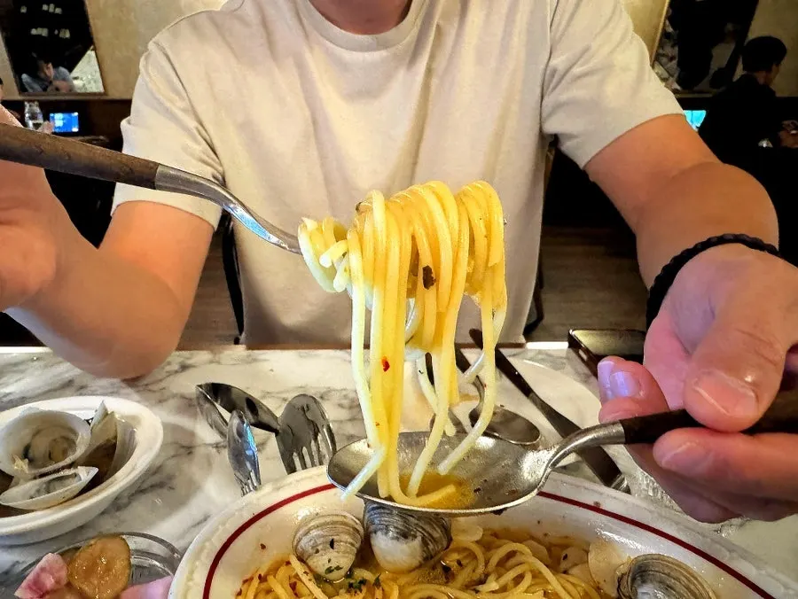 Gnocchi and vongole pasta side by side on the table
