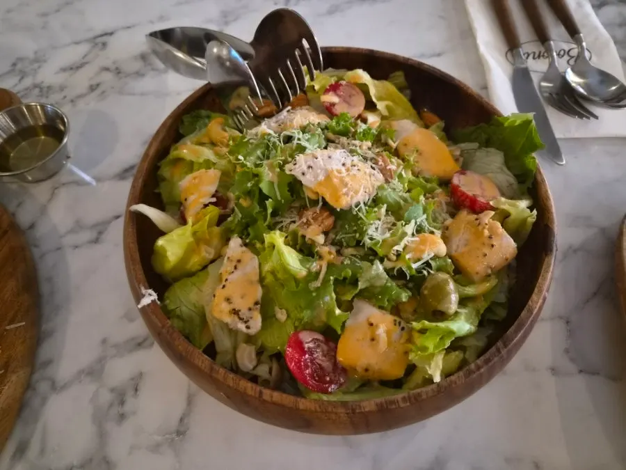 Chicken tenderloin salad topped with nuts and cheese