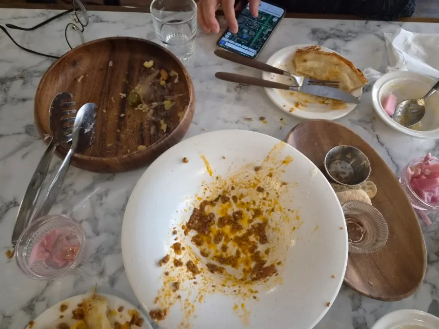 An empty pasta plate scraped clean of sauce