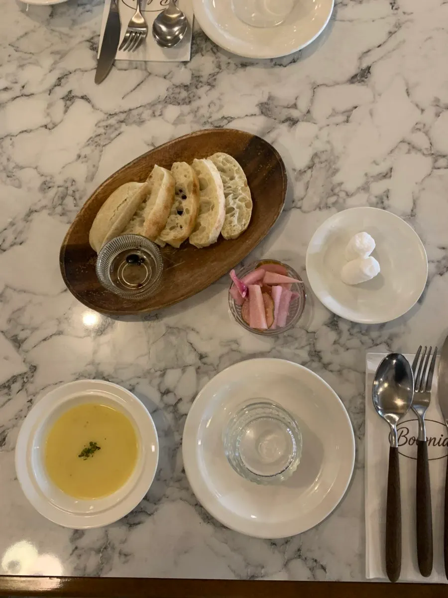 Complimentary bread, corn soup, and pickles