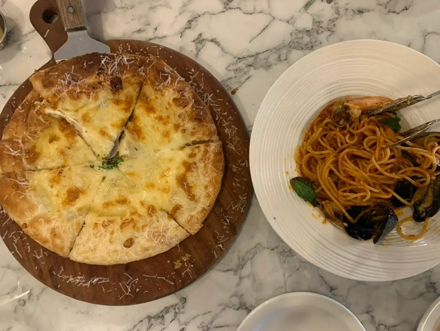 Pasta and pizza set out on the table