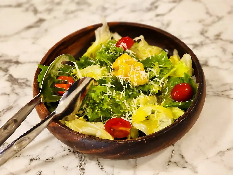 September seasonal salad topped with mango and cherry tomatoes